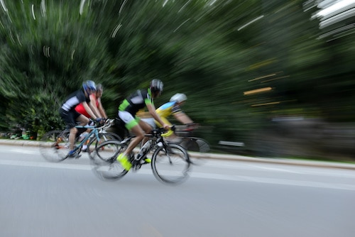 Blurred motion of Cyclists riding on bicycles at speed